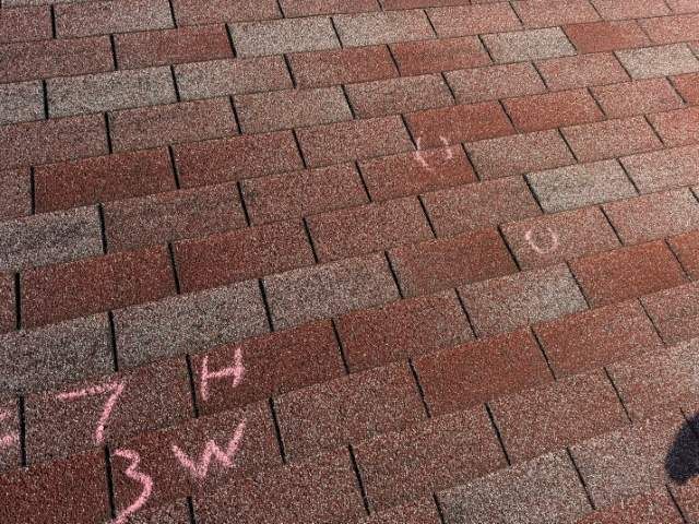 Hail hits marked with chalk on shingles on a Nixa, MO roof