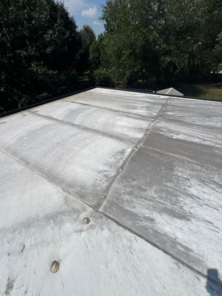 Coated low-slope roof section on a Nixa, Missouri home
