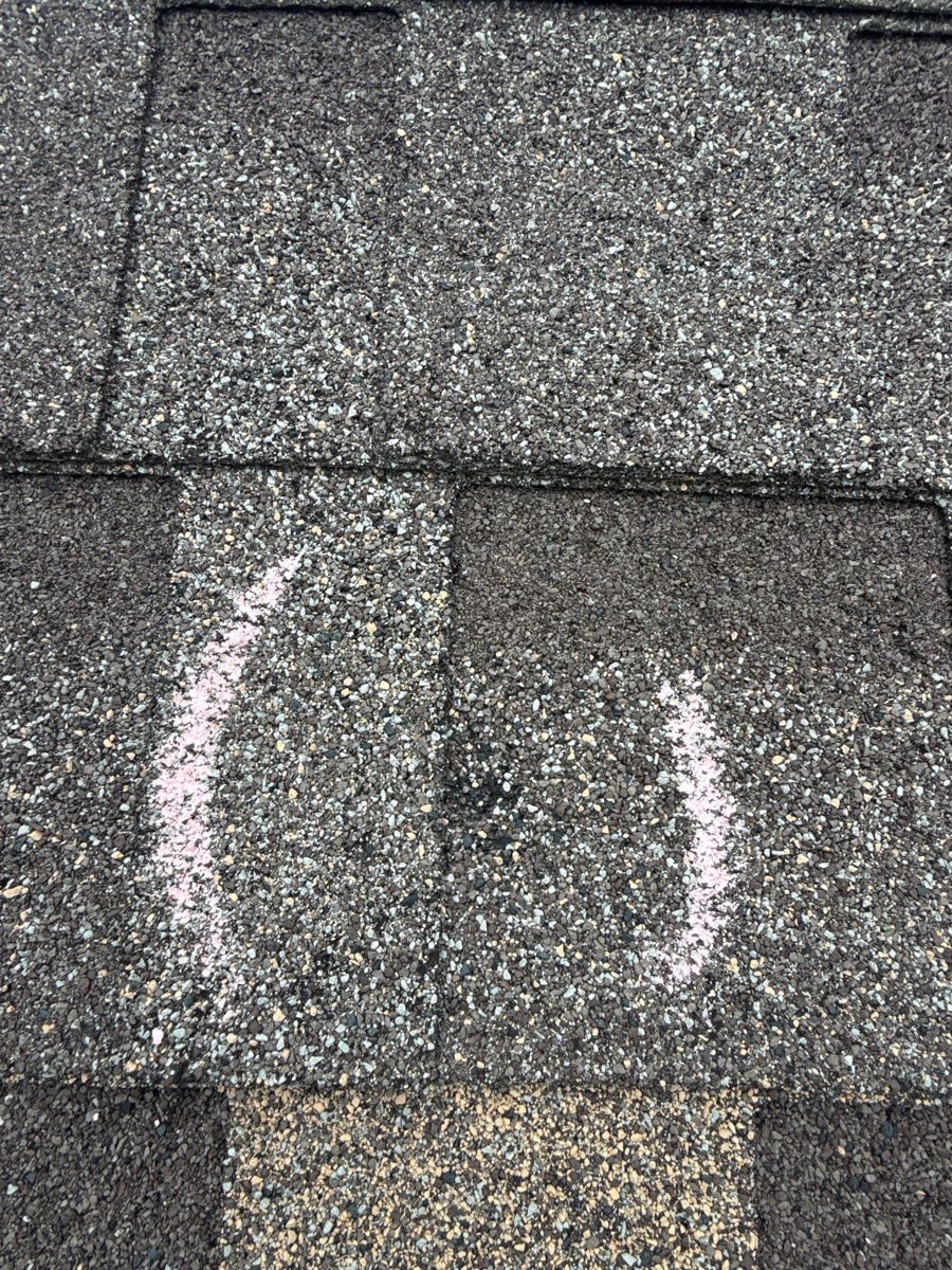 Hail damage marked on shingles in Republic, Missouri