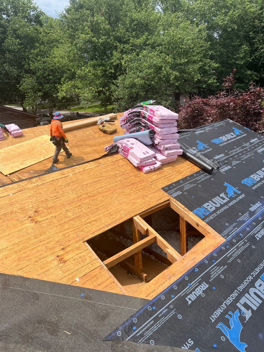 Crew replacing roof decking during a roof replacement in Republic, Missouri