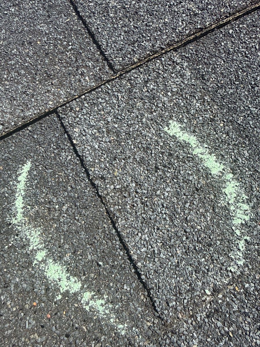 Hail hits marked with chalk on shingles in Springfield, Missouri