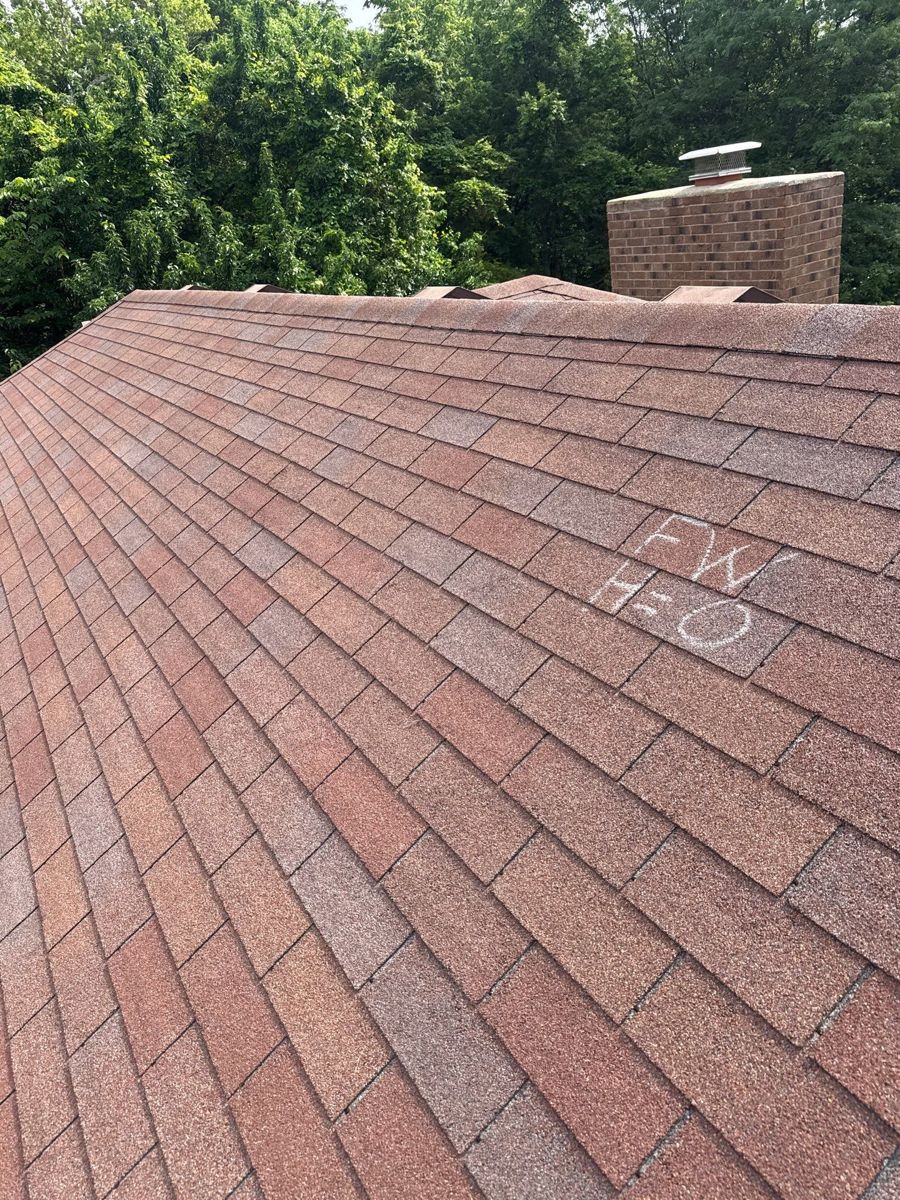 Roof inspection around a brick chimney on a Springfield, MO home